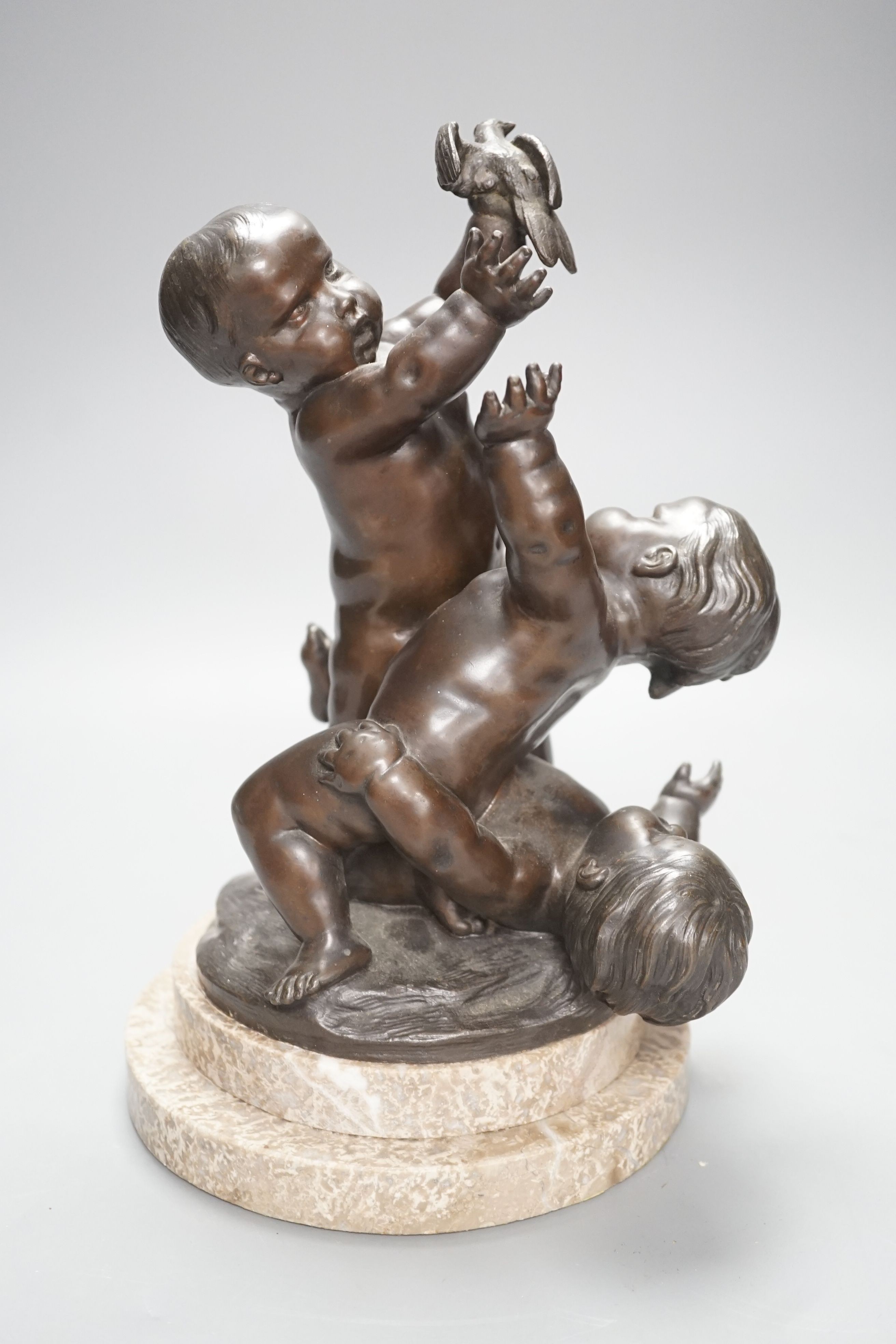 A bronze figure group of a trio of putto, height 28cm